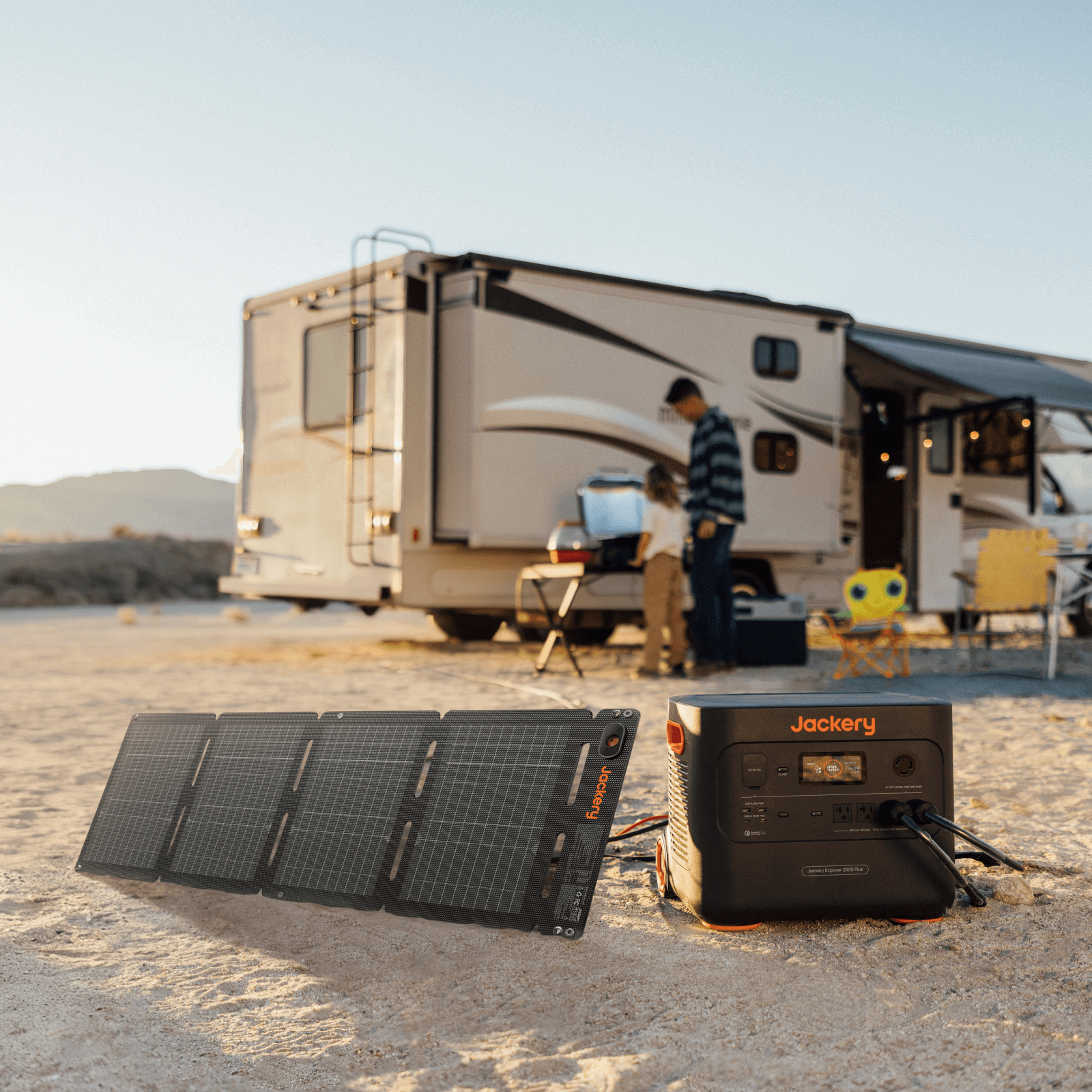 Solar panel and power station in front of an RV in a desert setting