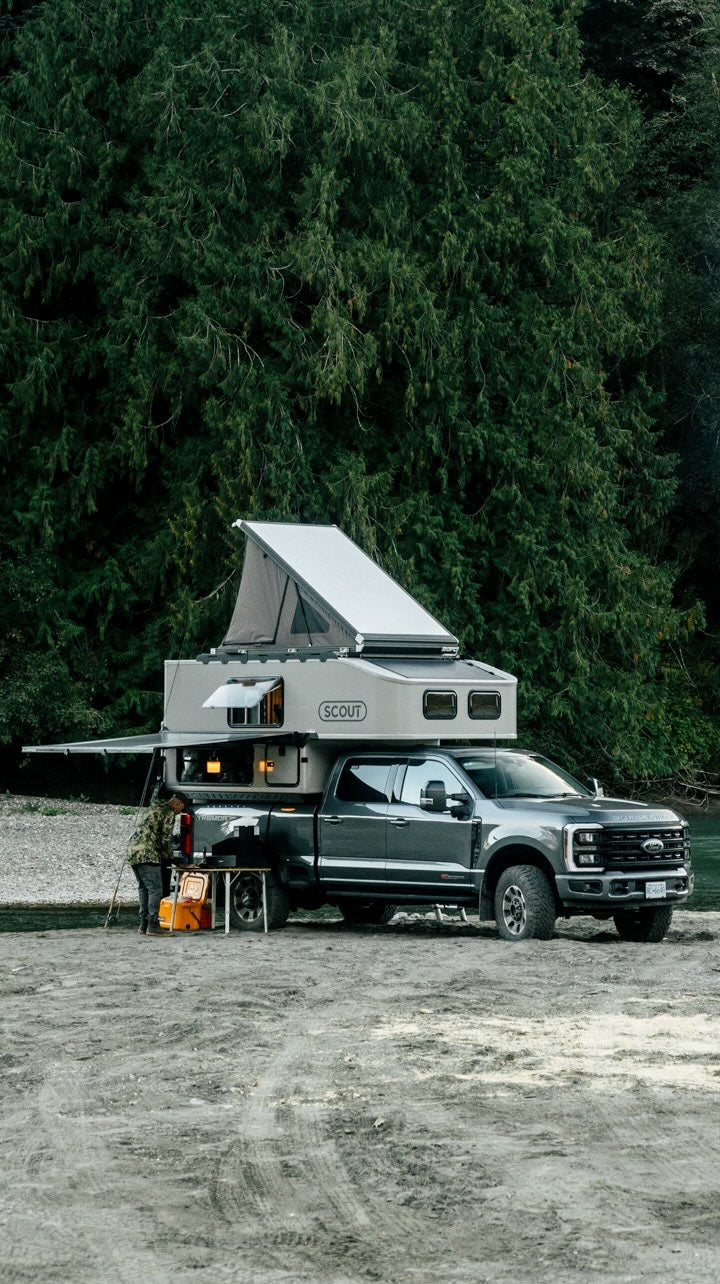 Scout hard sided slide-in truck camper at camp