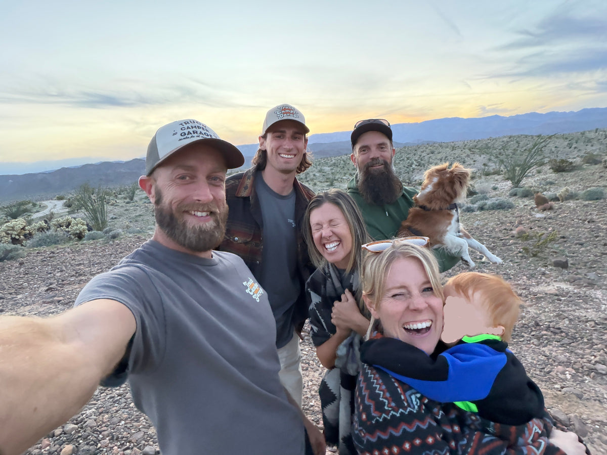 The Truck Camper Garage team with customers and their rigs