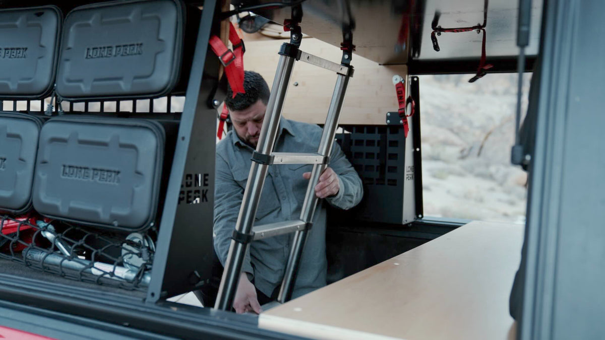 Low-profile mattress and bed ladder in a Lone Peak camper