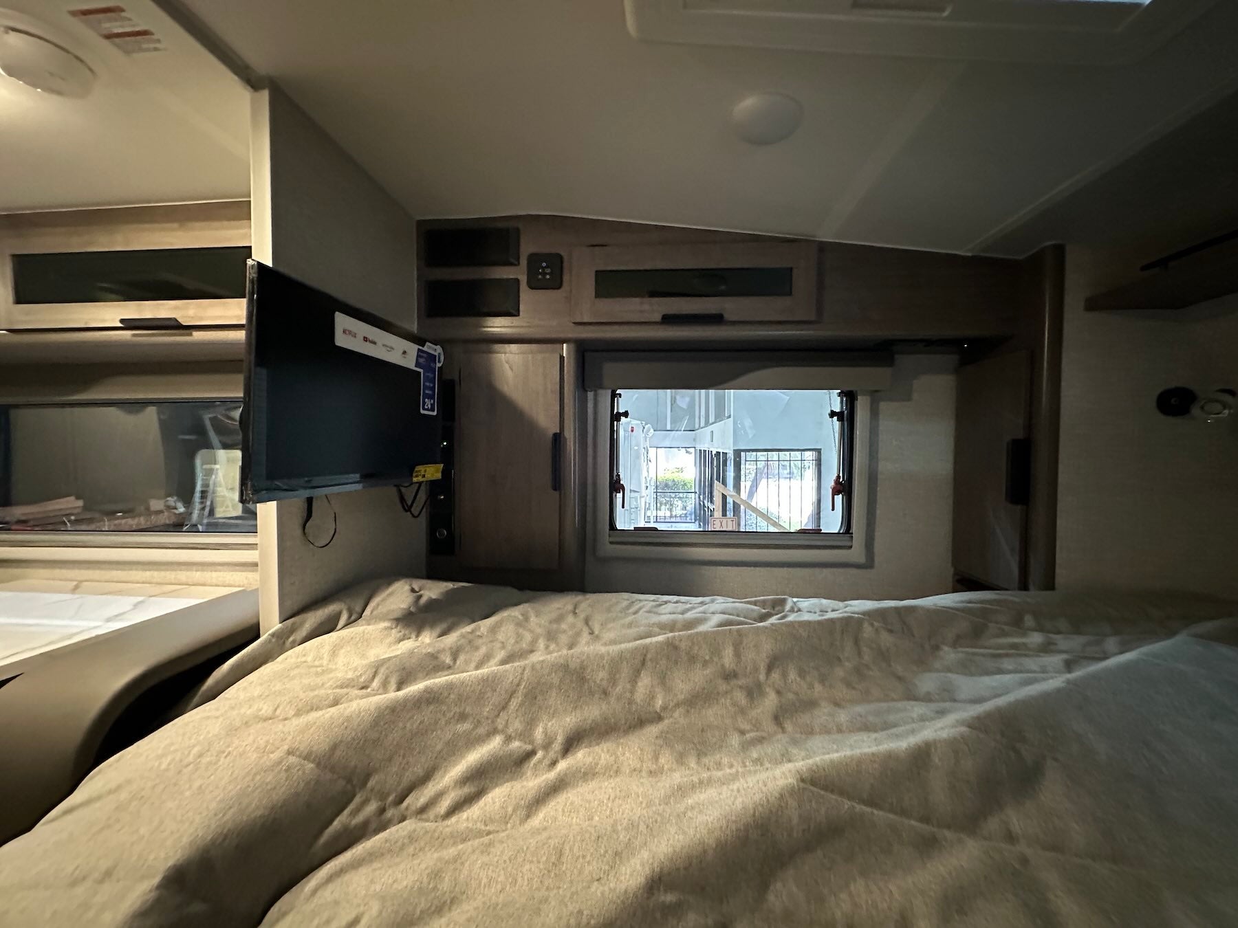 Interior of Lance 1191 cabover with a bed and small window