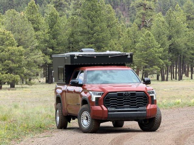 OVRLND camper topper on a flatbed utility bed