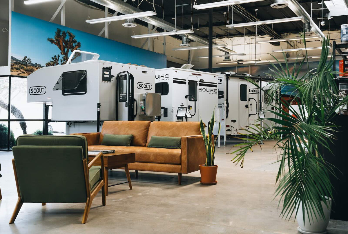 Truck campers lined up inside the Truck Camper Garage showroom